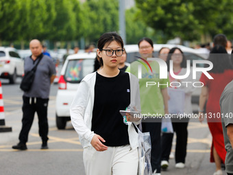 Candidates are walking into the test room for the 2024 National College entrance examination at Jinan Foreign Language School in Jinan, Chin...