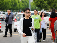 Candidates are walking into the test room for the 2024 National College entrance examination at Jinan Foreign Language School in Jinan, Chin...