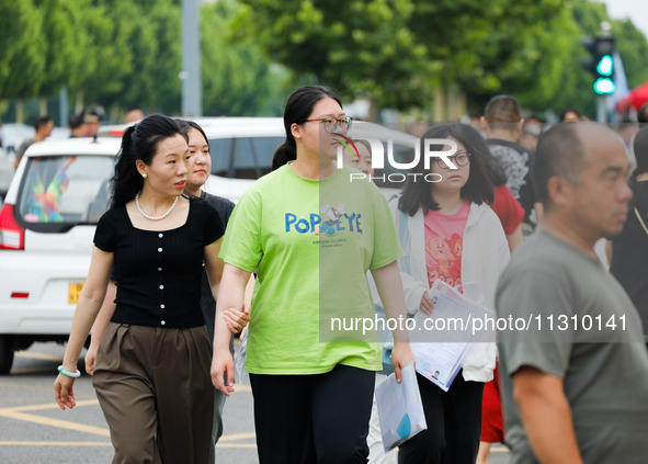 Candidates are walking into the test room for the 2024 National College entrance examination at Jinan Foreign Language School in Jinan, Chin...