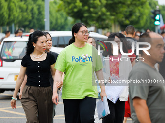 Candidates are walking into the test room for the 2024 National College entrance examination at Jinan Foreign Language School in Jinan, Chin...