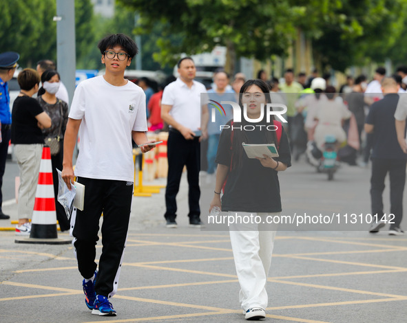 Candidates are walking into the test room for the 2024 National College entrance examination at Jinan Foreign Language School in Jinan, Chin...