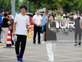 Candidates are walking into the test room for the 2024 National College entrance examination at Jinan Foreign Language School in Jinan, Chin...