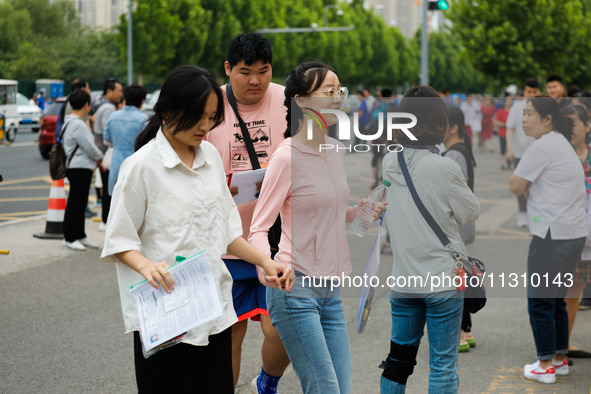 Candidates are walking into the test room for the 2024 National College entrance examination at Jinan Foreign Language School in Jinan, Chin...