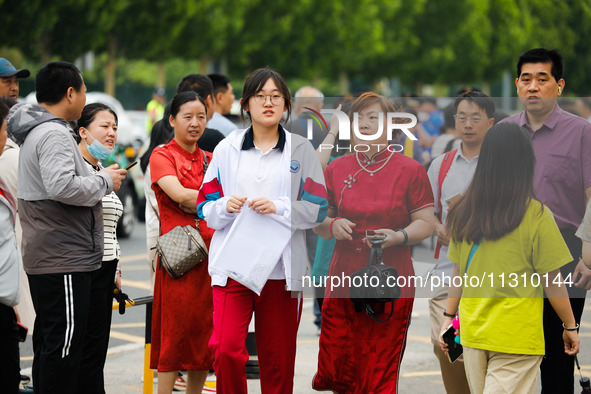 Candidates are walking into the test room for the 2024 National College entrance examination at Jinan Foreign Language School in Jinan, Chin...