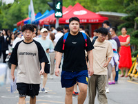 Candidates are walking into the test room for the 2024 National College entrance examination at Jinan Foreign Language School in Jinan, Chin...