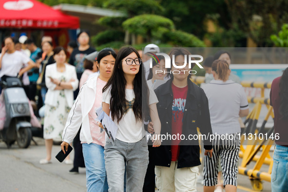 Candidates are walking into the test room for the 2024 National College entrance examination at Jinan Foreign Language School in Jinan, Chin...