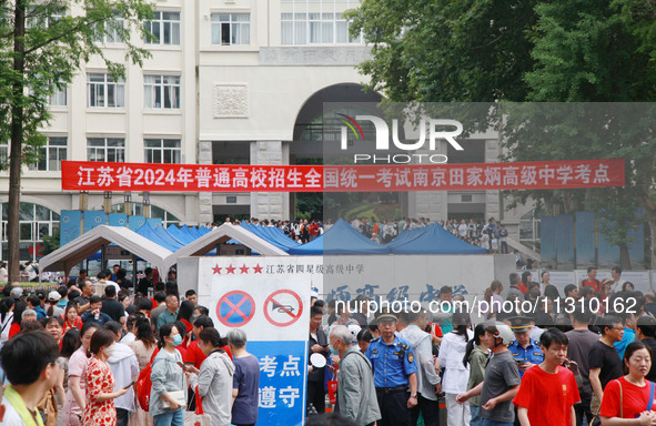 Candidates and parents are waiting at the entrance exam of Nanjing Tianjiabing Senior High School in Nanjing, China, on June 7, 2024. Accord...