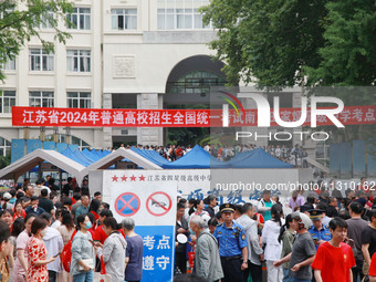 Candidates and parents are waiting at the entrance exam of Nanjing Tianjiabing Senior High School in Nanjing, China, on June 7, 2024. Accord...