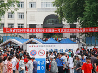 Candidates and parents are waiting at the entrance exam of Nanjing Tianjiabing Senior High School in Nanjing, China, on June 7, 2024. Accord...