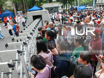 Parents are waiting outside as students are beginning to enter a gaokao test hall in Nanjing, China, on June 7, 2024. According to data rele...