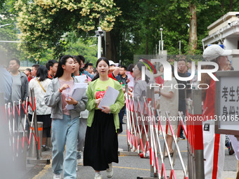 Candidates are starting to enter a college entrance examination point in Nanjing, China, on June 7, 2024. According to data released by the...