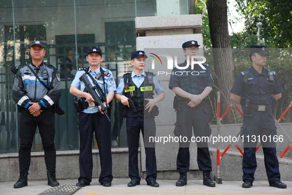 Police officers are guarding an entrance exam outside a college entrance examination site in Nanjing, China, on June 7, 2024. According to d...