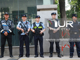 Police officers are guarding an entrance exam outside a college entrance examination site in Nanjing, China, on June 7, 2024. According to d...