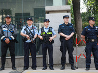 Police officers are guarding an entrance exam outside a college entrance examination site in Nanjing, China, on June 7, 2024. According to d...