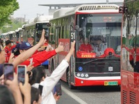 Citizens and volunteers are cheering for gaokao candidates outside a college entrance exam site in Yantai, China, on June 7, 2024. (