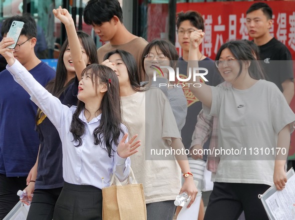 Students are posing for a group photo outside a college entrance examination point in Yantai, China, on June 7, 2024. 