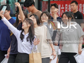 Students are posing for a group photo outside a college entrance examination point in Yantai, China, on June 7, 2024. (