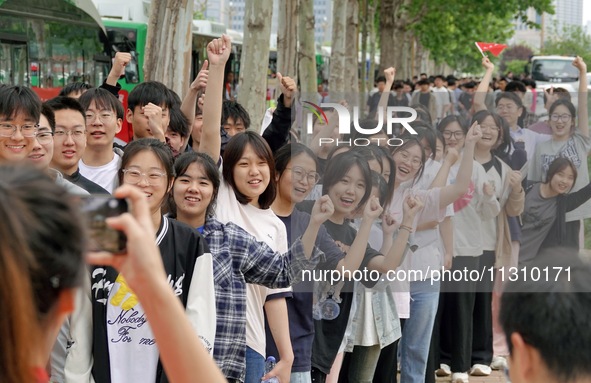 Students are posing for a group photo outside a college entrance examination point in Yantai, China, on June 7, 2024. 