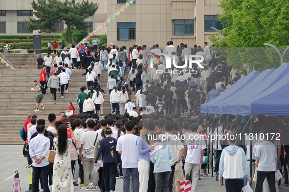 Students are walking into a test room outside a college entrance examination site in Yantai, China, on June 7, 2024. 