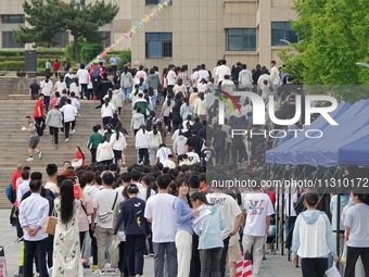 Students are walking into a test room outside a college entrance examination site in Yantai, China, on June 7, 2024. (