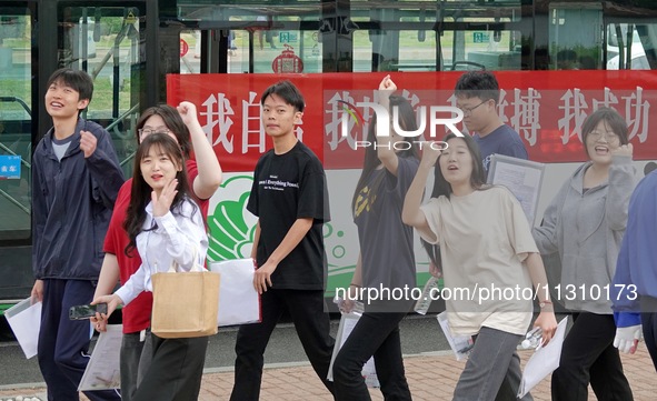 Candidates for the National College entrance examination are waving to teachers delivering exams outside a college entrance examination site...