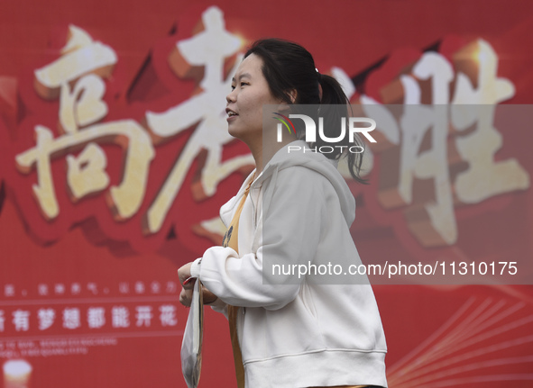 Students are walking into a test room outside Qingjiang Middle School College entrance examination site of the 2024 National College Entranc...