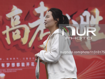 Students are walking into a test room outside Qingjiang Middle School College entrance examination site of the 2024 National College Entranc...