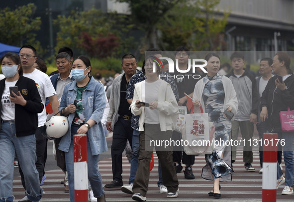 Students are walking into a test room outside Qingjiang Middle School College entrance examination site of the 2024 National College Entranc...