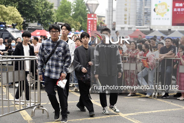 Students are walking into a test room outside Qingjiang Middle School College entrance examination site of the 2024 National College Entranc...