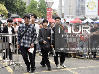 Students are walking into a test room outside Qingjiang Middle School College entrance examination site of the 2024 National College Entranc...