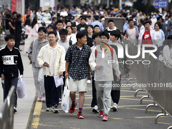 Students are walking into a test room outside Qingjiang Middle School College entrance examination site of the 2024 National College Entranc...