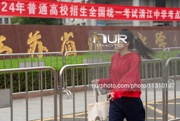 Students are walking into a test room outside Qingjiang Middle School College entrance examination site of the 2024 National College Entranc...