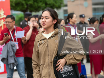 Students are walking into a test room outside Qingjiang Middle School College entrance examination site of the 2024 National College Entranc...