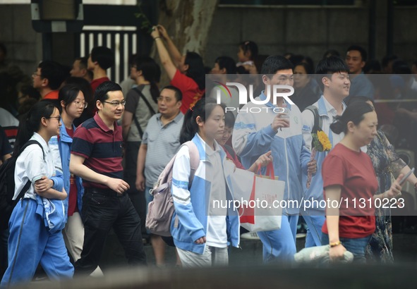 A large number of parents are greeting students coming out of a gaokao site after the 2024 National College Entrance exam in Hangzhou, China...