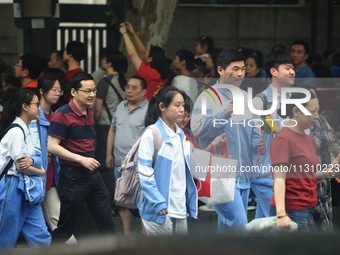 A large number of parents are greeting students coming out of a gaokao site after the 2024 National College Entrance exam in Hangzhou, China...