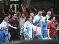 A large number of parents are greeting students coming out of a gaokao site after the 2024 National College Entrance exam in Hangzhou, China...