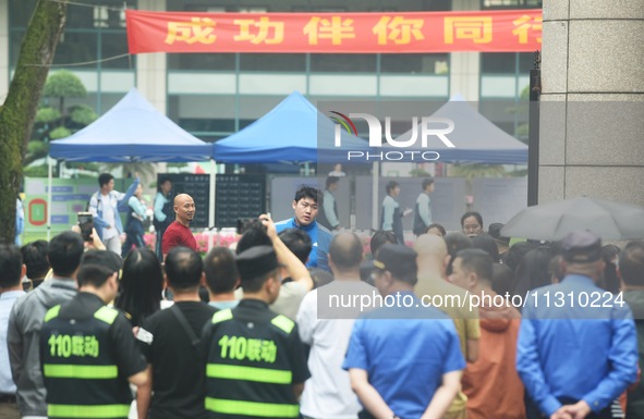 A large number of parents are greeting students coming out of a gaokao site after the 2024 National College Entrance exam in Hangzhou, China...