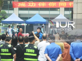 A large number of parents are greeting students coming out of a gaokao site after the 2024 National College Entrance exam in Hangzhou, China...