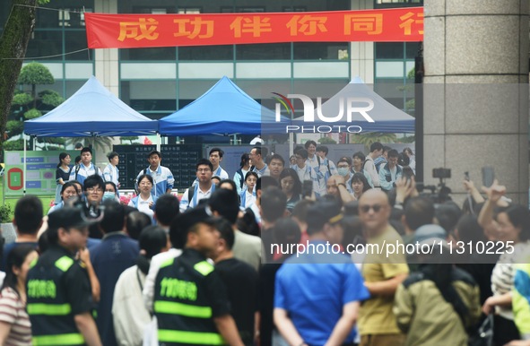 A large number of parents are greeting students coming out of a gaokao site after the 2024 National College Entrance exam in Hangzhou, China...