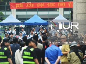 A large number of parents are greeting students coming out of a gaokao site after the 2024 National College Entrance exam in Hangzhou, China...