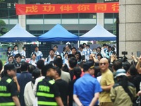 A large number of parents are greeting students coming out of a gaokao site after the 2024 National College Entrance exam in Hangzhou, China...