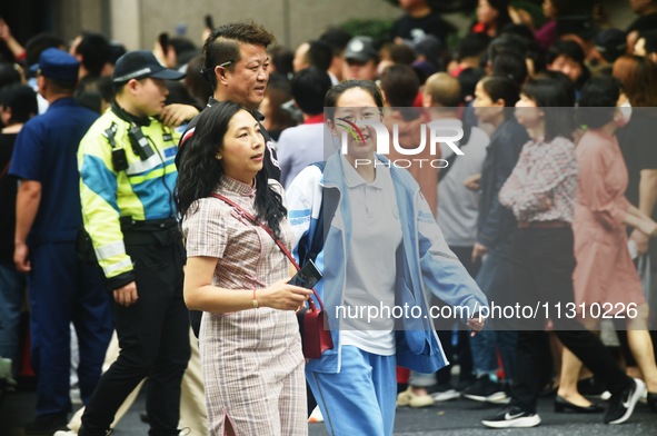 A large number of parents are greeting students coming out of a gaokao site after the 2024 National College Entrance exam in Hangzhou, China...