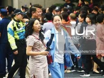 A large number of parents are greeting students coming out of a gaokao site after the 2024 National College Entrance exam in Hangzhou, China...