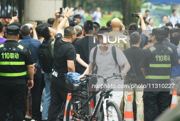 A large number of parents are greeting students coming out of a gaokao site after the 2024 National College Entrance exam in Hangzhou, China...