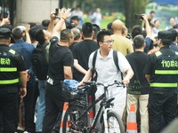 A large number of parents are greeting students coming out of a gaokao site after the 2024 National College Entrance exam in Hangzhou, China...