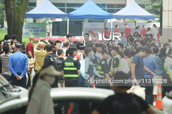 A large number of parents are greeting students coming out of a gaokao site after the 2024 National College Entrance exam in Hangzhou, China...