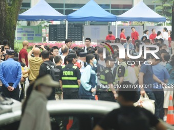 A large number of parents are greeting students coming out of a gaokao site after the 2024 National College Entrance exam in Hangzhou, China...