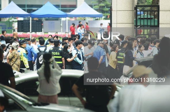 A large number of parents are greeting students coming out of a gaokao site after the 2024 National College Entrance exam in Hangzhou, China...