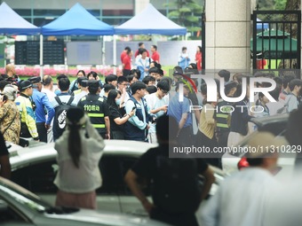 A large number of parents are greeting students coming out of a gaokao site after the 2024 National College Entrance exam in Hangzhou, China...