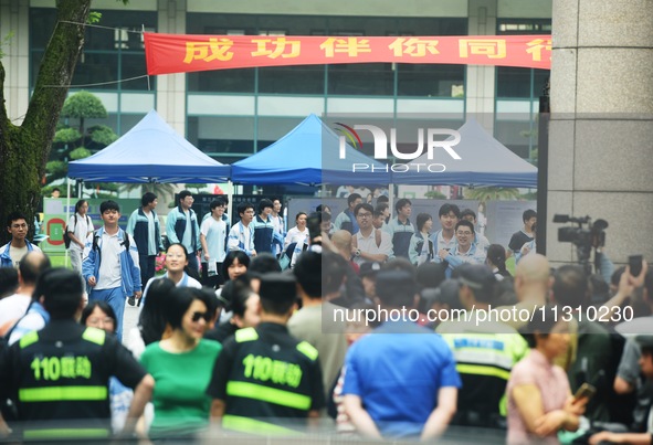 A large number of parents are greeting students coming out of a gaokao site after the 2024 National College Entrance exam in Hangzhou, China...